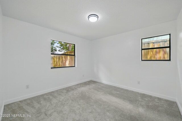 494 Acacia St, Saint Augustine Beach, FL 32080 - carpeted spare room featuring baseboards
