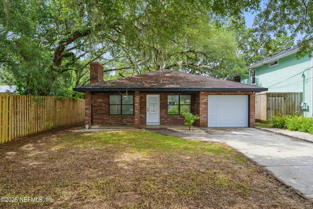 494 Acacia St, Saint Augustine Beach, FL 32080 - view of front of property with a chimney, driveway, a garage, brick siding, and roof with shingles