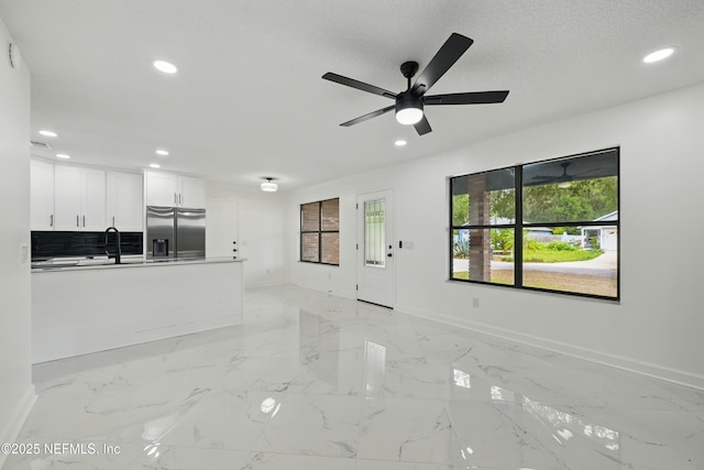 494 Acacia St, Saint Augustine Beach, FL 32080 - unfurnished living room featuring recessed lighting, baseboards, light marble finish floors, ceiling fan, and a sink
