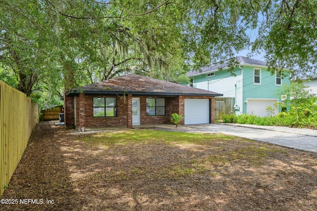 494 Acacia St, Saint Augustine Beach, FL 32080 - view of front facade featuring concrete driveway, brick siding, and an attached garage