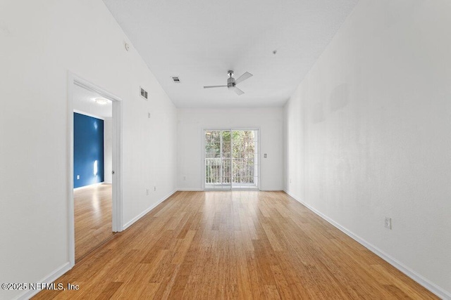 5006 Key Lime Dr Unit 306, Jacksonville, FL 32256 - empty room with light wood finished floors, ceiling fan, and baseboards
