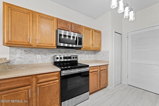 5006 Key Lime Dr Unit 306, Jacksonville, FL 32256 - kitchen with appliances with stainless steel finishes, light countertops, tasteful backsplash, and a chandelier