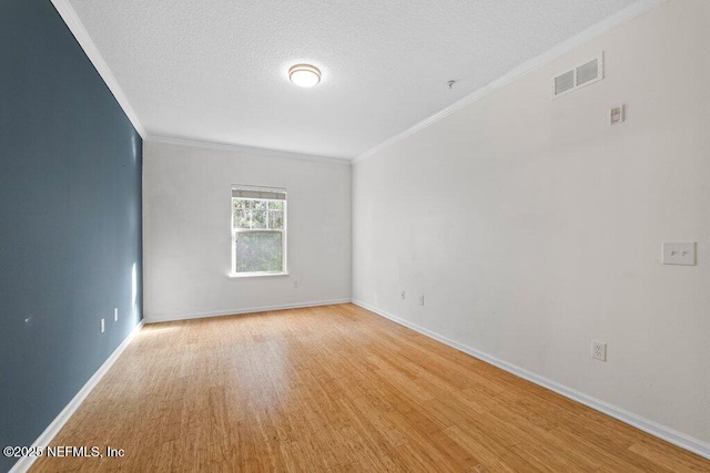 5006 Key Lime Dr Unit 306, Jacksonville, FL 32256 - empty room with crown molding, light wood finished floors, baseboards, and a textured ceiling