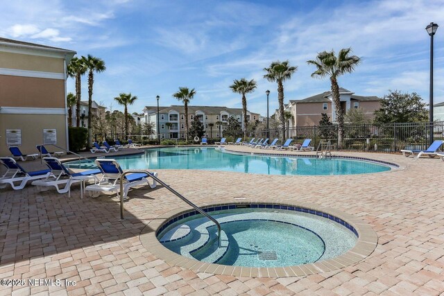 5006 Key Lime Dr Unit 306, Jacksonville, FL 32256 - community pool featuring a hot tub, a patio, and a residential view
