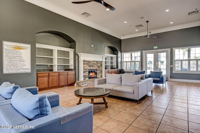 5006 Key Lime Dr Unit 306, Jacksonville, FL 32256 - living room featuring a ceiling fan, light tile patterned floors, a stone fireplace, healthy amount of natural light, and ornamental molding