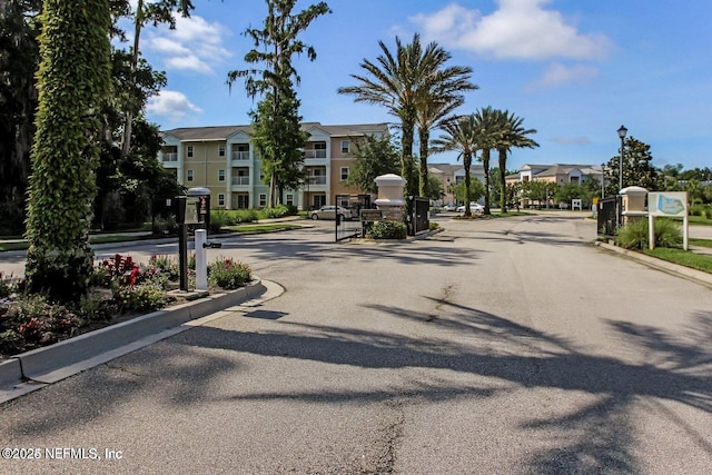 5006 Key Lime Dr Unit 306, Jacksonville, FL 32256 - view of asphalt road with street lights, curbs, a residential view, and a gated entry
