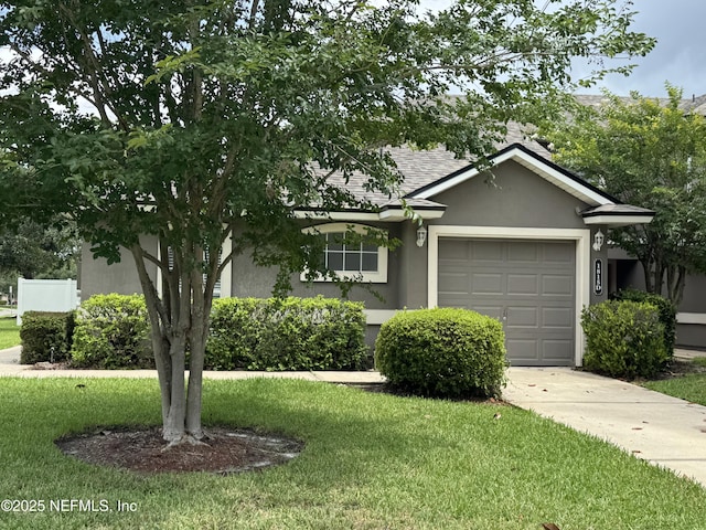 1815 Green Springs Cir Unit D, Fleming Island, FL 32003 - view of front of house with stucco siding, an attached garage, a front lawn, and concrete driveway