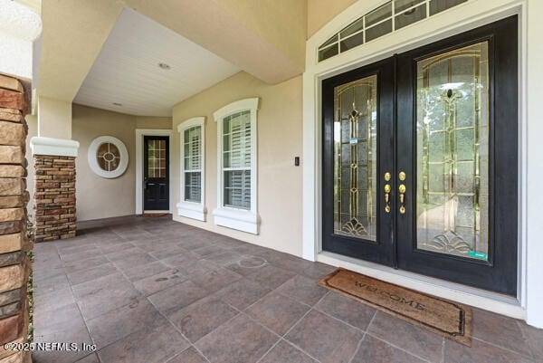 1821 Wind Ridge Ct, Fleming Island, FL 32003 - view of exterior entry with french doors and stucco siding