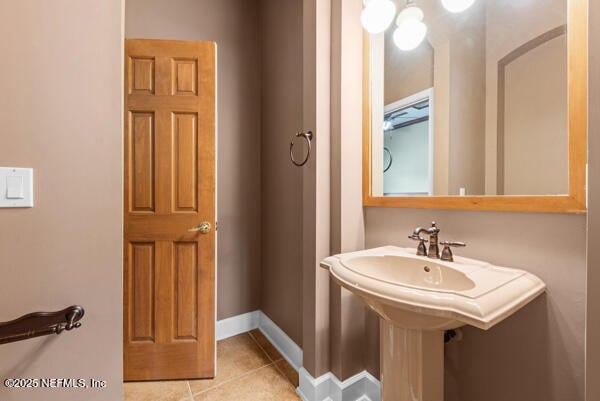 1821 Wind Ridge Ct, Fleming Island, FL 32003 - bathroom with tile patterned flooring, baseboards, and a sink
