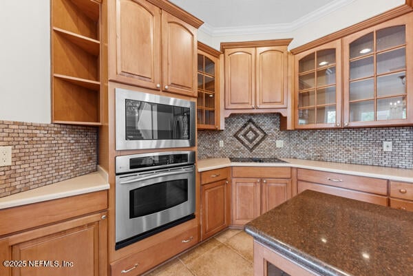1821 Wind Ridge Ct, Fleming Island, FL 32003 - kitchen with appliances with stainless steel finishes, glass insert cabinets, tasteful backsplash, ornamental molding, and light tile patterned flooring
