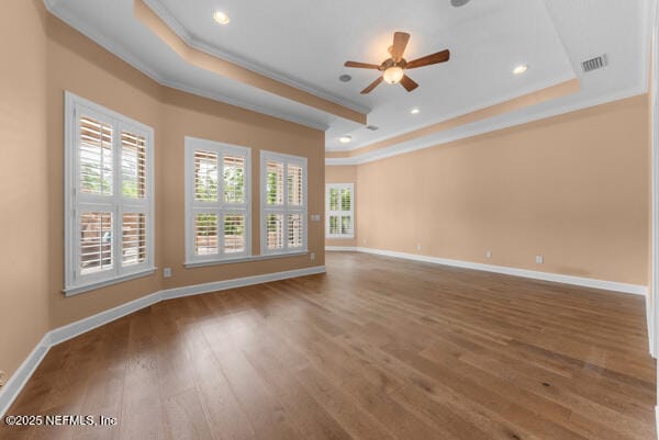 1821 Wind Ridge Ct, Fleming Island, FL 32003 - unfurnished room with a raised ceiling, crown molding, baseboards, a ceiling fan, and wood finished floors