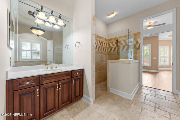 1821 Wind Ridge Ct, Fleming Island, FL 32003 - bathroom featuring a walk in shower, healthy amount of natural light, vanity, and baseboards