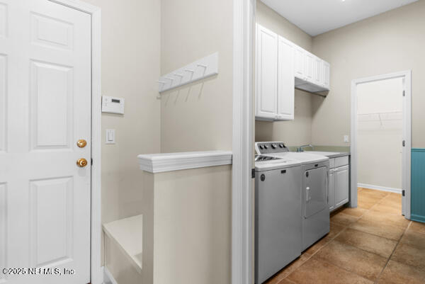 1821 Wind Ridge Ct, Fleming Island, FL 32003 - washroom featuring cabinet space, washing machine and dryer, and baseboards