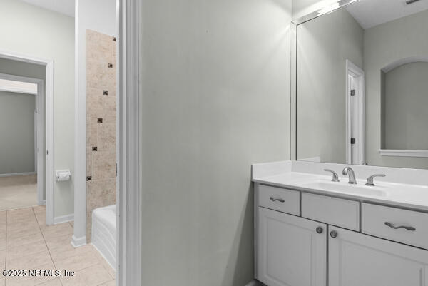 1821 Wind Ridge Ct, Fleming Island, FL 32003 - full bath with vanity, tile patterned floors, baseboards, and bathtub / shower combination