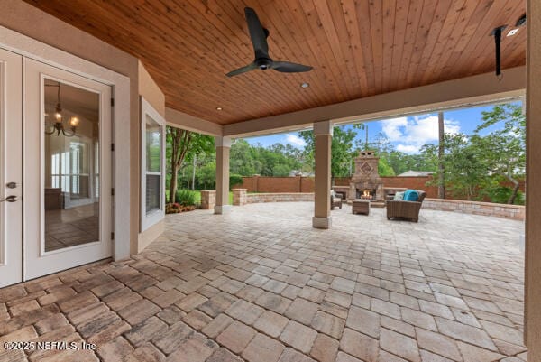 1821 Wind Ridge Ct, Fleming Island, FL 32003 - view of patio with a warm lit fireplace and ceiling fan