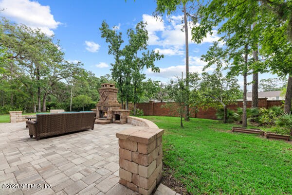 1821 Wind Ridge Ct, Fleming Island, FL 32003 - view of yard with a patio and an outdoor living space with a fireplace