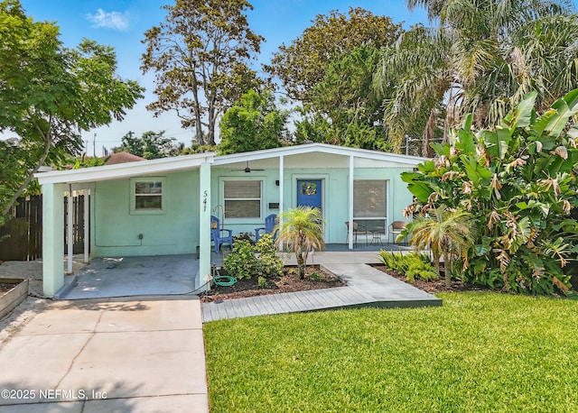 541 Margaret St, Neptune Beach, FL 32266 - view of front facade with a front yard, covered porch, and stucco siding