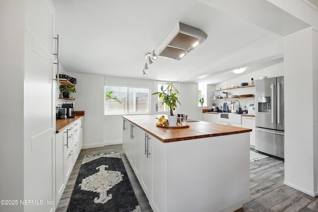 541 Margaret St, Neptune Beach, FL 32266 - kitchen featuring stainless steel refrigerator with ice dispenser, wooden counters, open shelves, ventilation hood, and plenty of natural light