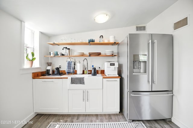 541 Margaret St, Neptune Beach, FL 32266 - kitchen with stainless steel refrigerator with ice dispenser, light wood-type flooring, a sink, and wooden counters