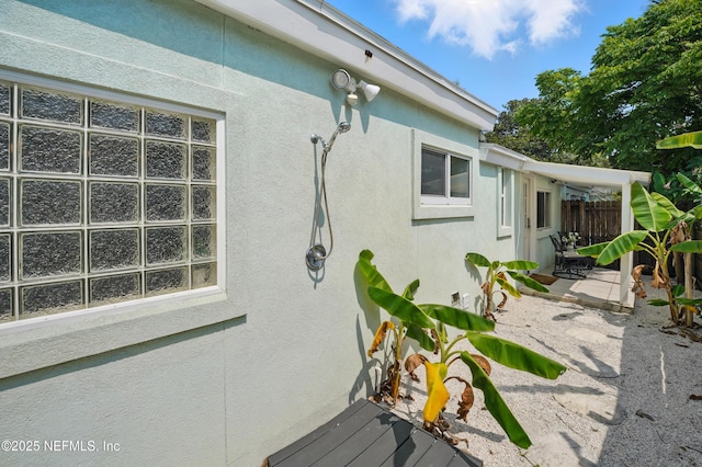 541 Margaret St, Neptune Beach, FL 32266 - view of side of home with stucco siding and a patio area