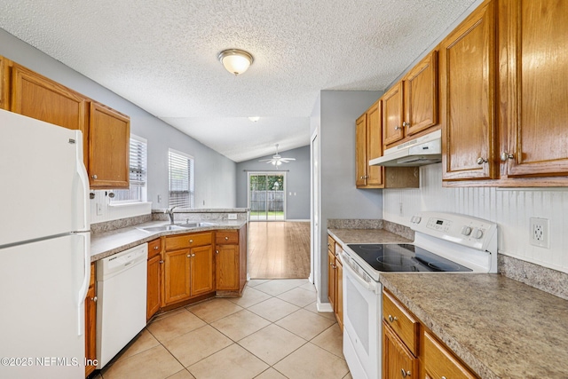 1645 Teaberry Dr, Middleburg, FL 32068 - kitchen featuring white appliances, under cabinet range hood, lofted ceiling, light tile patterned floors, and a textured ceiling