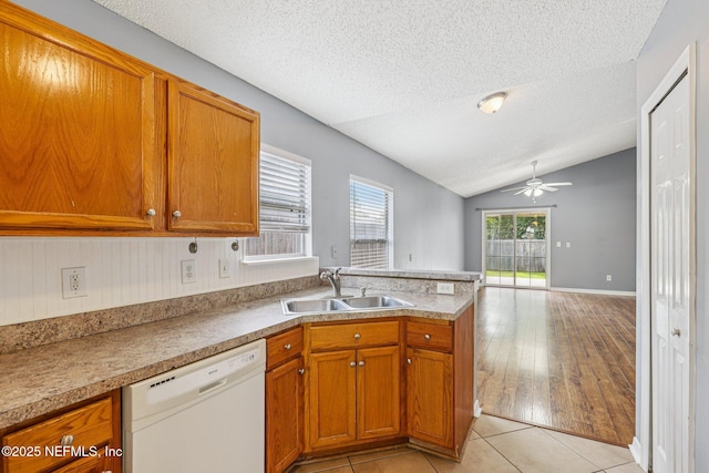 1645 Teaberry Dr, Middleburg, FL 32068 - kitchen featuring dishwasher, a textured ceiling, a peninsula, brown cabinets, and ceiling fan