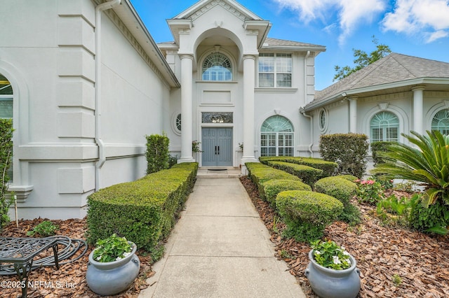 4427 Royal Tern Ct, Jacksonville Beach, FL 32250 - doorway to property with stucco siding and roof with shingles
