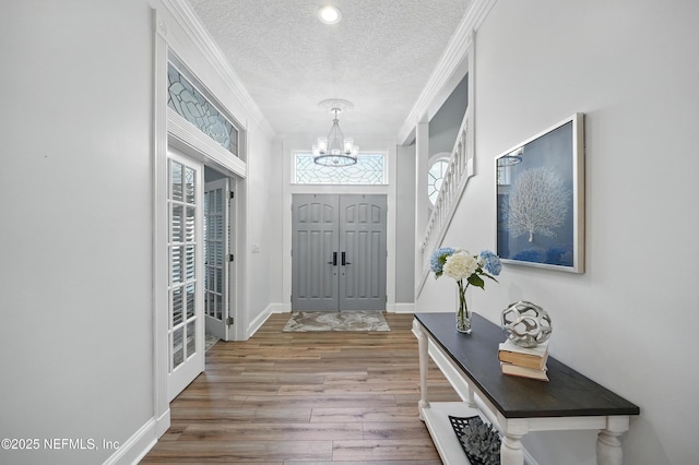 4427 Royal Tern Ct, Jacksonville Beach, FL 32250 - foyer entrance featuring a chandelier, a textured ceiling, ornamental molding, wood finished floors, and recessed lighting