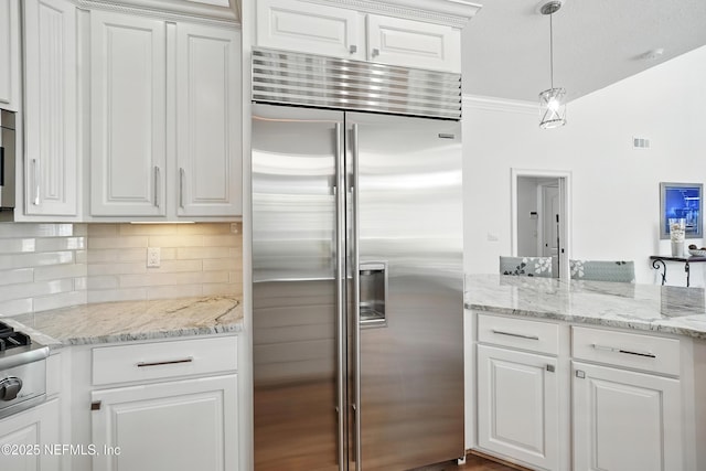 4427 Royal Tern Ct, Jacksonville Beach, FL 32250 - kitchen with stainless steel appliances, tasteful backsplash, white cabinets, decorative light fixtures, and light stone countertops