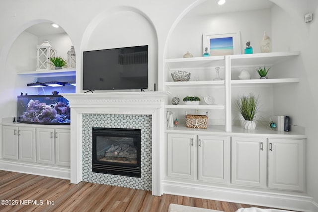 4427 Royal Tern Ct, Jacksonville Beach, FL 32250 - living room with a tile fireplace, wood finished floors, and recessed lighting