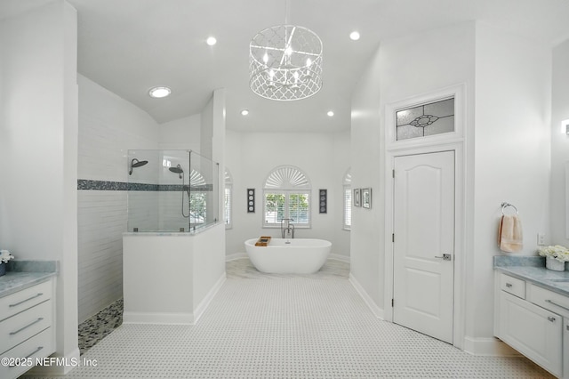 4427 Royal Tern Ct, Jacksonville Beach, FL 32250 - bathroom featuring walk in shower, a freestanding tub, vanity, recessed lighting, and a chandelier