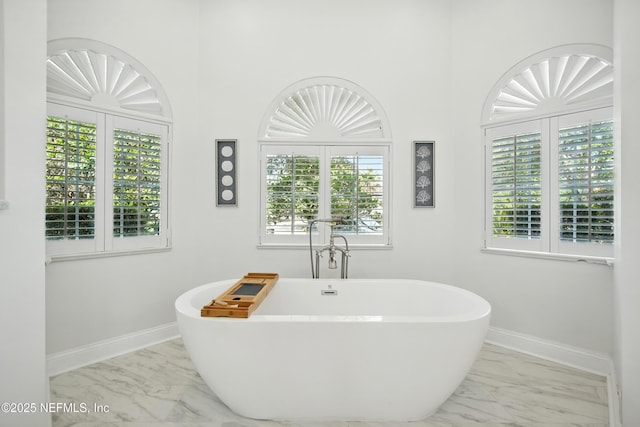 4427 Royal Tern Ct, Jacksonville Beach, FL 32250 - bathroom with marble look tile flooring and a freestanding bath