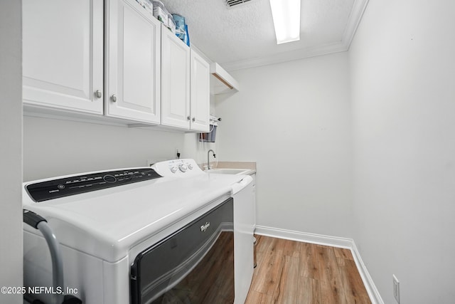 4427 Royal Tern Ct, Jacksonville Beach, FL 32250 - washroom featuring cabinet space, light wood-style flooring, crown molding, washing machine and clothes dryer, and a textured ceiling