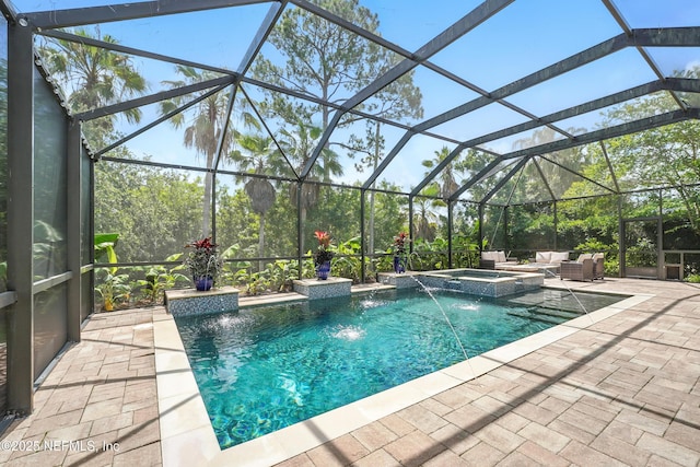 4427 Royal Tern Ct, Jacksonville Beach, FL 32250 - view of pool with a patio, an outdoor hangout area, glass enclosure, and a pool with connected hot tub