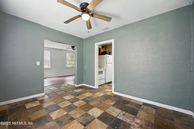 1176 Dancy St, Jacksonville, FL 32205 - unfurnished room featuring stone tile floors, ceiling fan, and baseboards