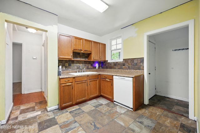 1176 Dancy St, Jacksonville, FL 32205 - kitchen with white dishwasher, stone tile floors, a sink, decorative backsplash, and light countertops