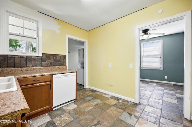 1176 Dancy St, Jacksonville, FL 32205 - kitchen featuring dishwasher, stone tile flooring, baseboards, and backsplash