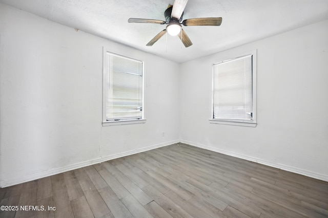 1176 Dancy St, Jacksonville, FL 32205 - empty room with wood finished floors, a ceiling fan, and baseboards