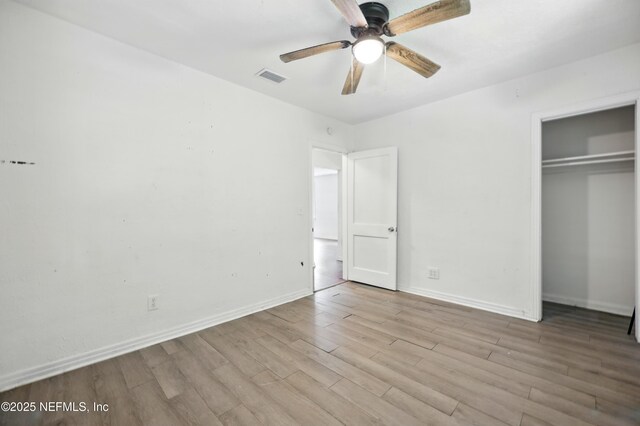 1176 Dancy St, Jacksonville, FL 32205 - unfurnished bedroom with wood finished floors, a closet, baseboards, and a ceiling fan