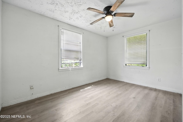 1176 Dancy St, Jacksonville, FL 32205 - empty room with wood finished floors, ceiling fan, and baseboards
