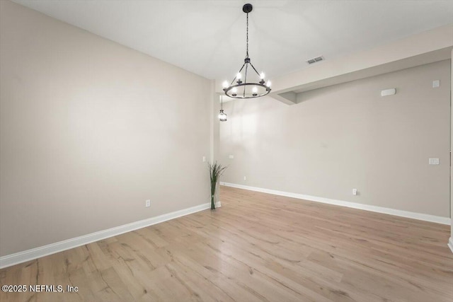 286 Holly Landing Way, Saint Augustine, FL 32092 - spare room featuring a chandelier, wood finished floors, and baseboards