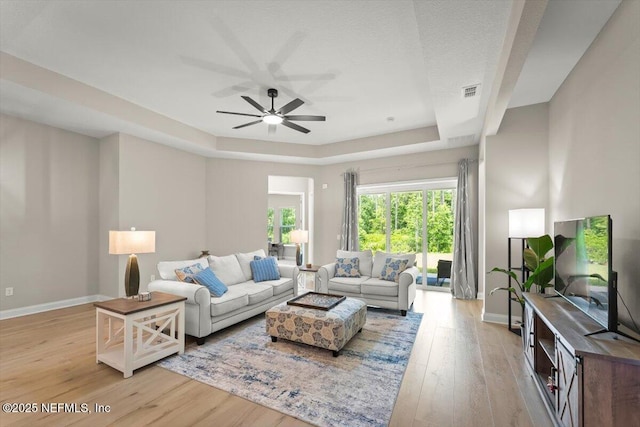286 Holly Landing Way, Saint Augustine, FL 32092 - living room with a tray ceiling, light wood finished floors, baseboards, and ceiling fan