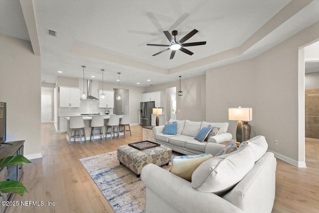 286 Holly Landing Way, Saint Augustine, FL 32092 - living area with a tray ceiling, ceiling fan, light wood-type flooring, baseboards, and recessed lighting