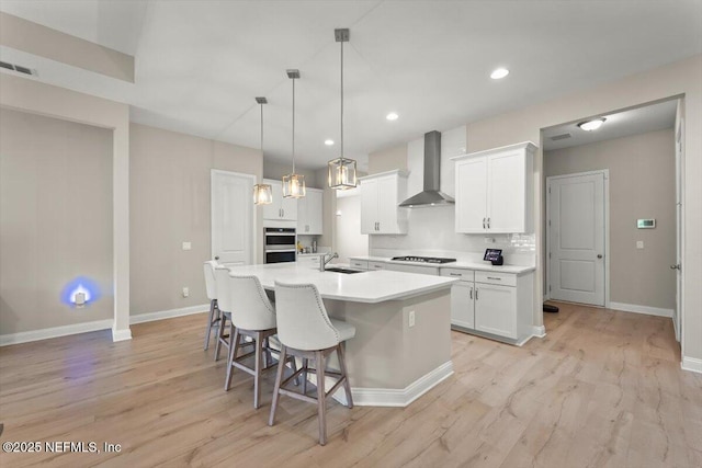 286 Holly Landing Way, Saint Augustine, FL 32092 - kitchen with wall chimney range hood, a sink, light wood-type flooring, baseboards, and recessed lighting