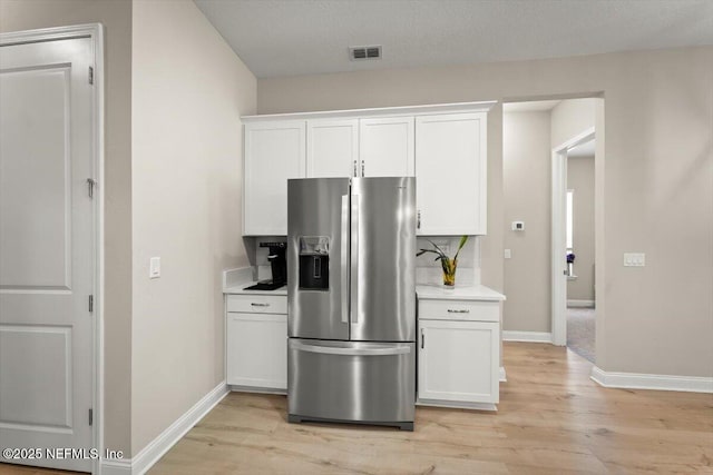 286 Holly Landing Way, Saint Augustine, FL 32092 - kitchen with stainless steel refrigerator with ice dispenser, light wood-style flooring, baseboards, and white cabinetry