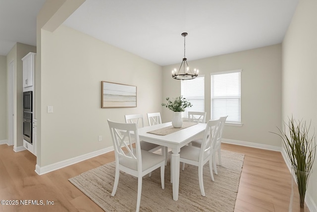 286 Holly Landing Way, Saint Augustine, FL 32092 - dining space featuring light wood-type flooring, a chandelier, and baseboards