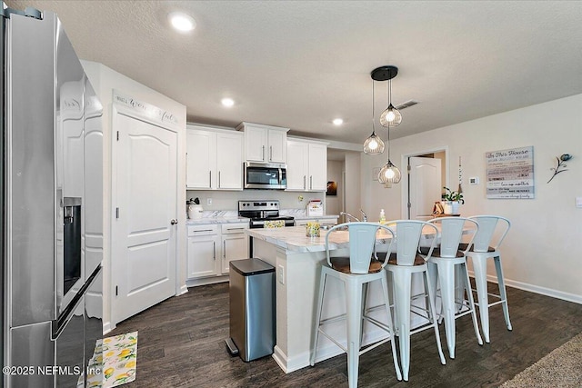 3448 Cliffside Way, Green Cove Springs, FL 32043 - kitchen with stainless steel appliances, dark wood-style floors, light countertops, white cabinetry, and recessed lighting
