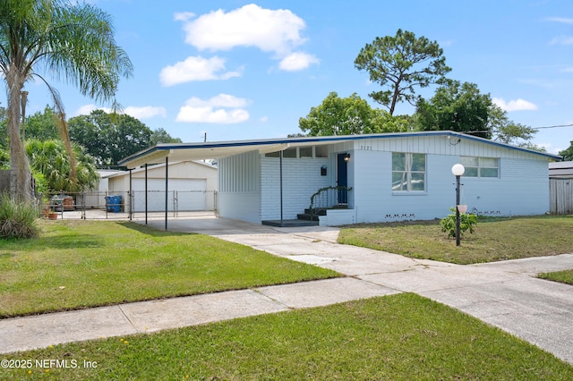 3121 Holly Berry Ln, Jacksonville, FL 32277 - view of front of home featuring driveway, an outbuilding, an attached carport, and entry steps
