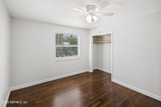 3121 Holly Berry Ln, Jacksonville, FL 32277 - unfurnished bedroom with dark wood-style floors, a closet, ceiling fan, and a textured ceiling