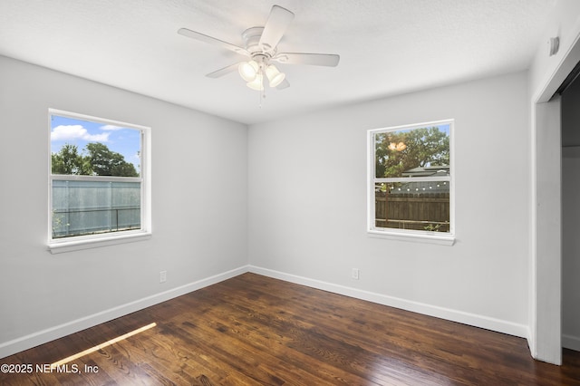 3121 Holly Berry Ln, Jacksonville, FL 32277 - empty room featuring healthy amount of natural light, ceiling fan, and dark wood-style flooring